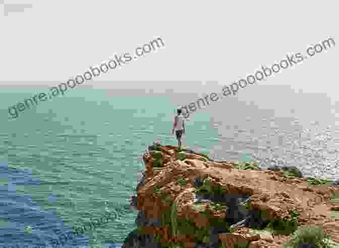 A Person Standing On A Cliff's Edge, Looking Out At The Vast Ocean. Divine Turbulence: Navigating The Amorphous Winds Of Life