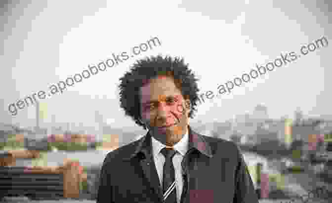 Lemn Sissay, A Black Man With A Shaved Head And Goatee, Smiles At The Camera. He Is Wearing A Black Shirt And A Silver Chain. Listener Lemn Sissay